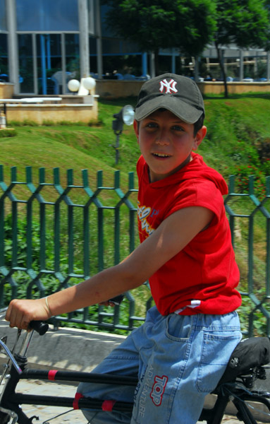 Boy on a bike with a NY Yankees hat, Hama