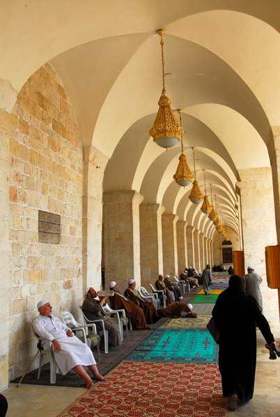 Men resting in the arcade of the Umayyad Mosque