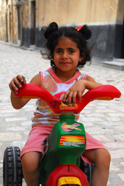 Girl on a tricycle, Al Jalloum - Al Sur, Aleppo