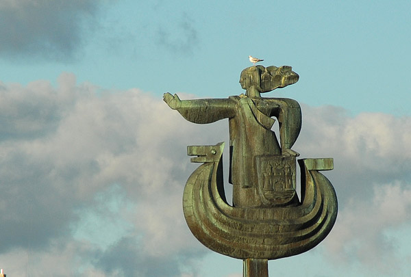 Daugava  sculpture, a female figure standing in a viking-style boat with the Riga coat-of-arms