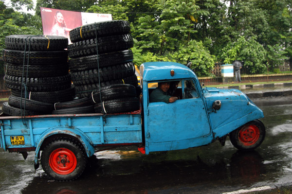 Old truck overloaded with tires