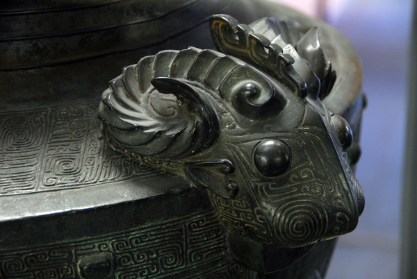 Detail of bronze container with three rams heads (ca 1500-1027 BC)