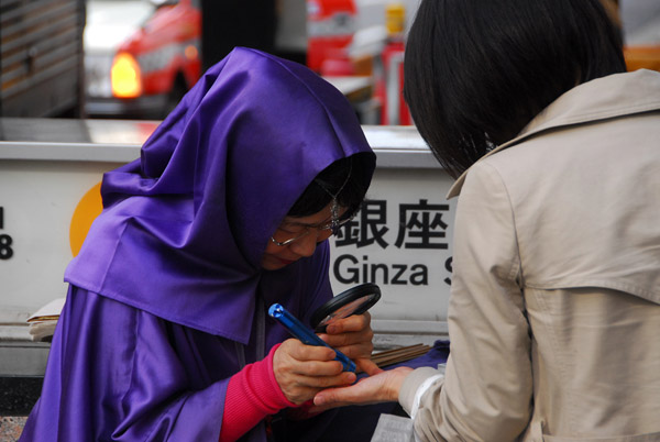 Fortuneteller working the sidewalk, Ginza