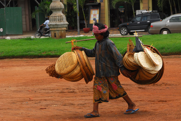 Basket selling walking along the riverfront, Phnom Penh