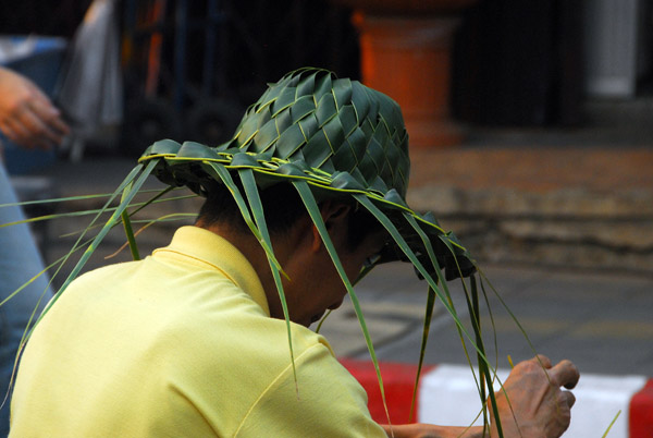 Man wearing a hat woven from palm fronds
