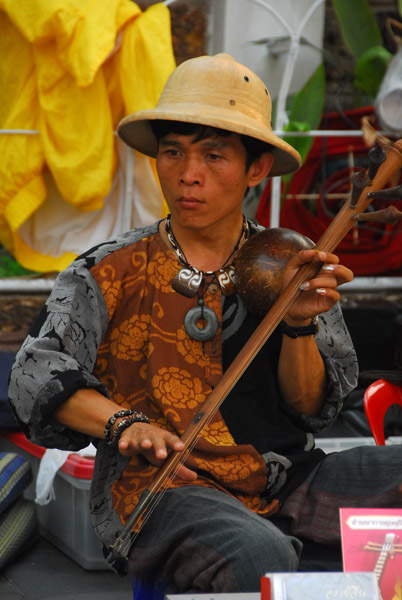Man playing a traditional instrument, Chiang Mai
