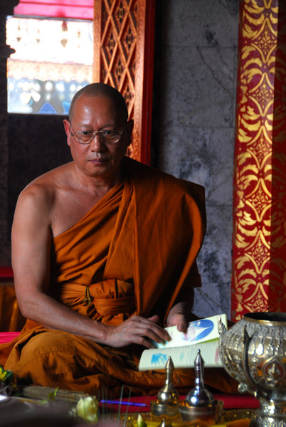 Senior monk speaking with visitors to the vihara