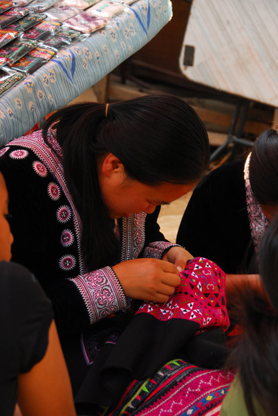 Hmong women embroidering