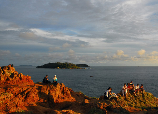 Others waiting on the rocks for sunset with Ko Kaeo Yai in the distance