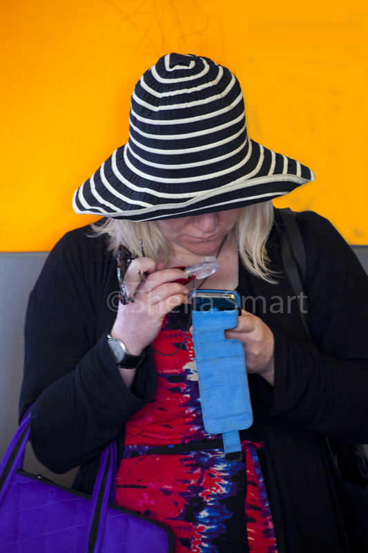 Woman in striped hat with magnifying glass