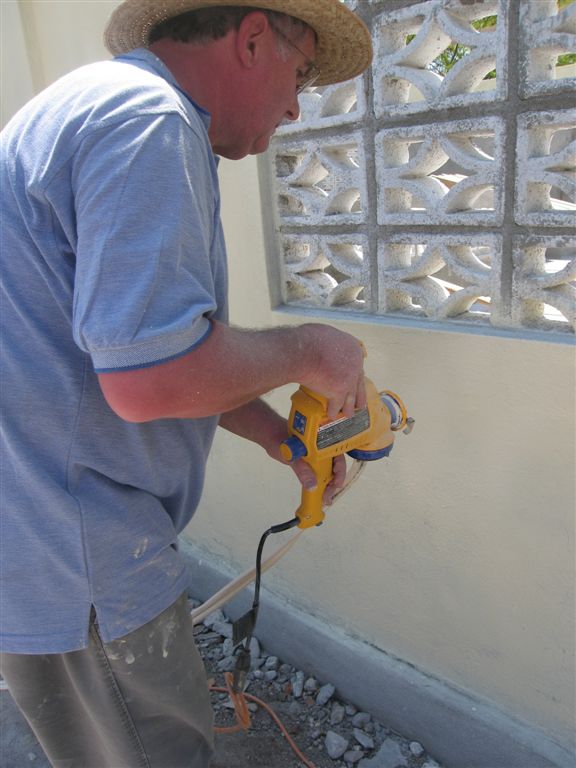 Bill spraying paint on the walls