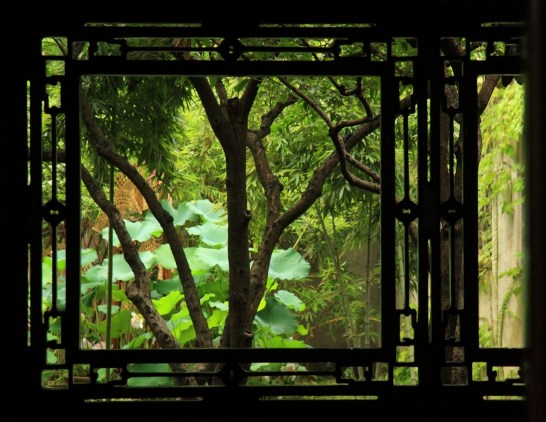 View through an ornate window at The Humble Administrator's Garden, Suzhou