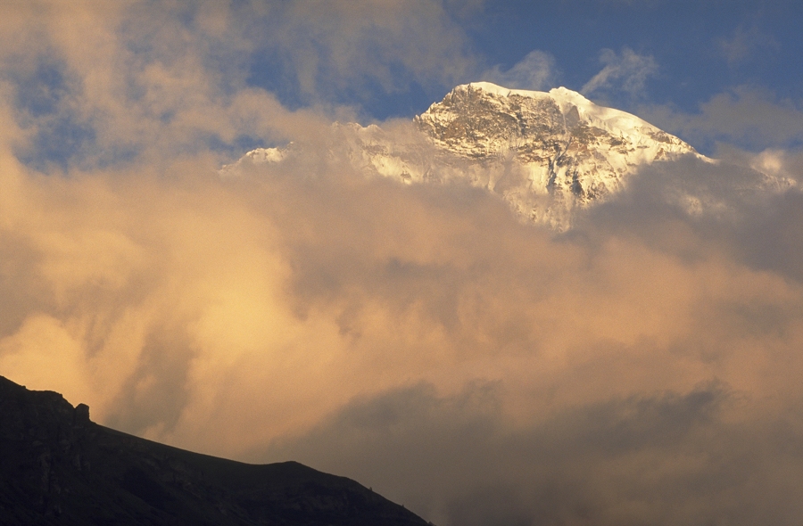 Jungfrau peak above clouds at sunset