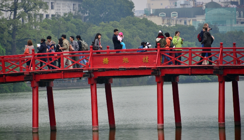 tourists on The Huc Bridge, Hoan Kiem Lake, Hanoi, Vietnam  