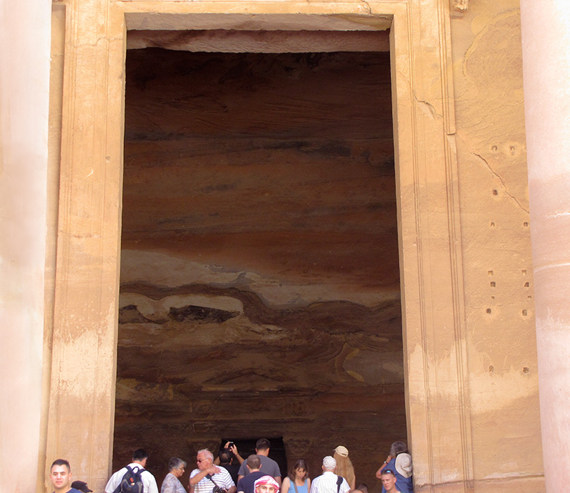 At the huge doorway, a glimpse of the interior