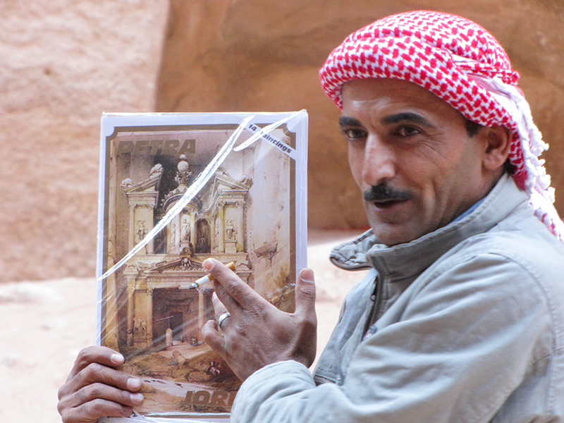 A guide compares Petra past w/ what theyre seeing, Using David Roberts Yr-1839 drawings