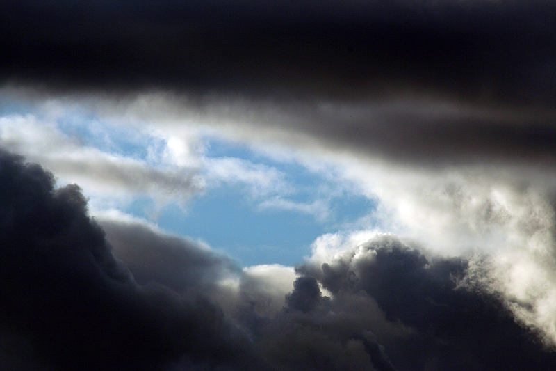 Bright blue sky behind the moody clouds