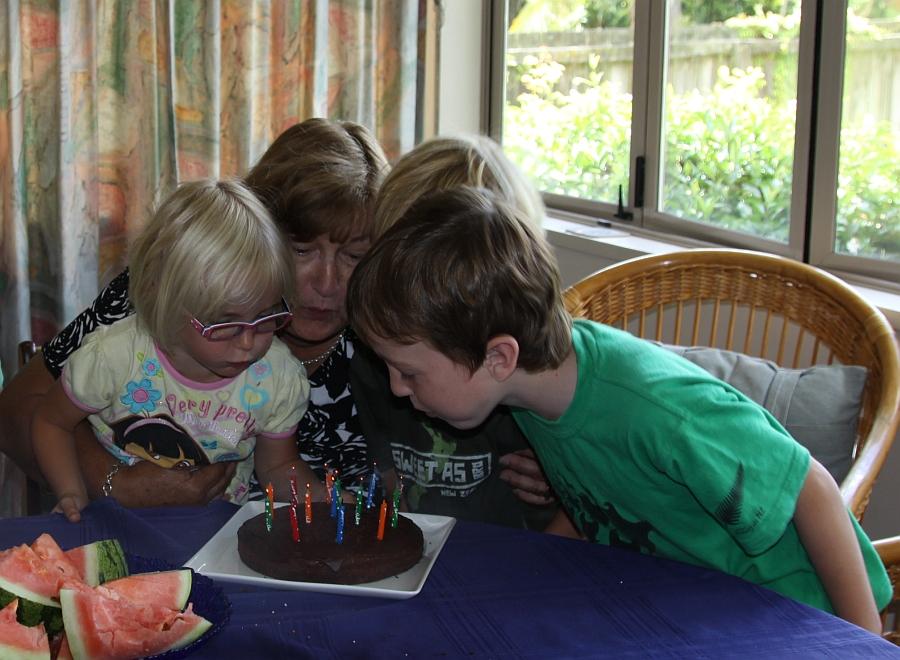 Grandchn helping me to blow out the candles