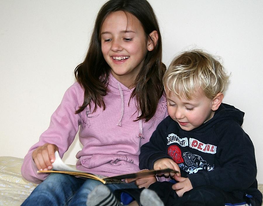 Molly reading to her little cousin Toby