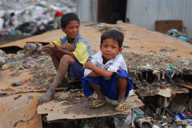 Two boys taking a rest at the landfill.