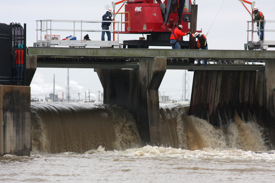 A view through the open bays of the Spillway to industry across the River