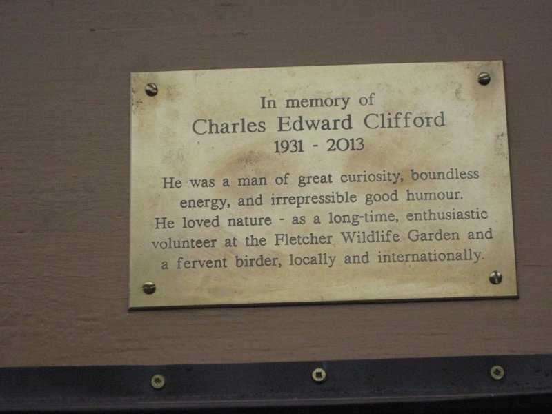 Brass plaque dedicating the feeder to Charlie