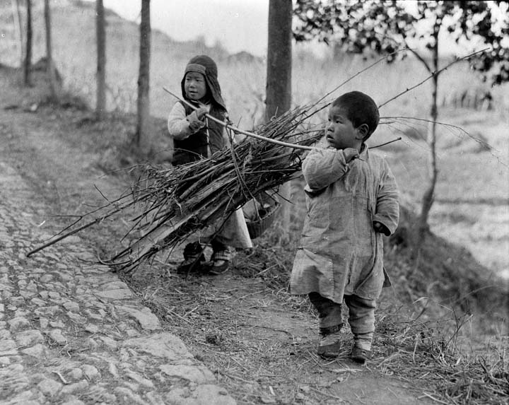 c. 1918 - Carrying firewood