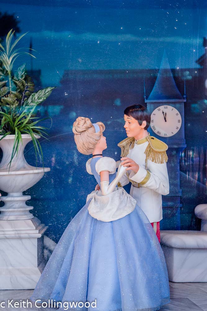 Cinderella dances in a window display.