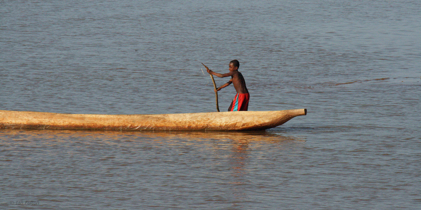 A boy in a boat on the River Manambolo