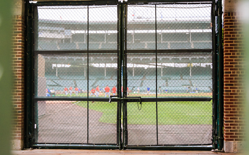 Looking into Wrigley Field through the fence on Sheffield Avenue