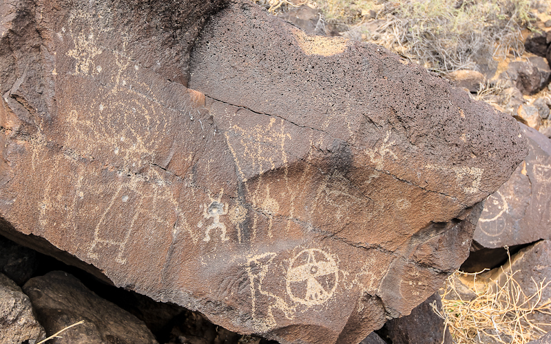 Figures including flutists in Piedras Marcadas Canyon in Petroglyph National Monument