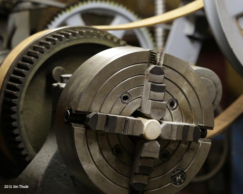 Turned the small end on a lathe and hand filed to fit metal fitting
