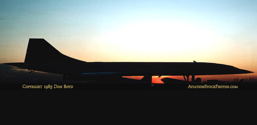 1985 - a British Airways Concorde and two DC-3s parked on E-Satellite remote positions at sunset