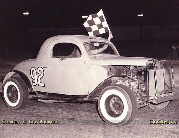 1955 - Otis Bodiford with the checkered flag in Old 92 in the early days at Hialeah Speedway