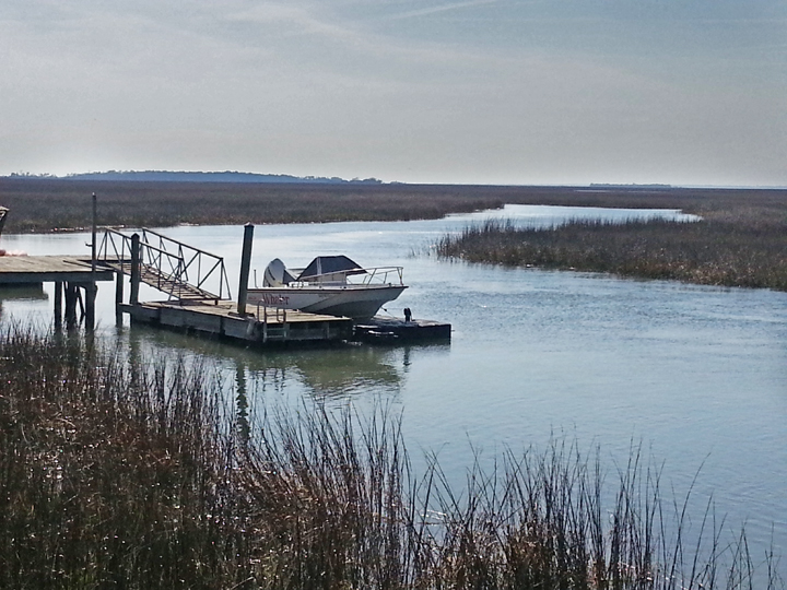 Boat and dock on a large salt water marsh - approaching the beach area on Tybee Island