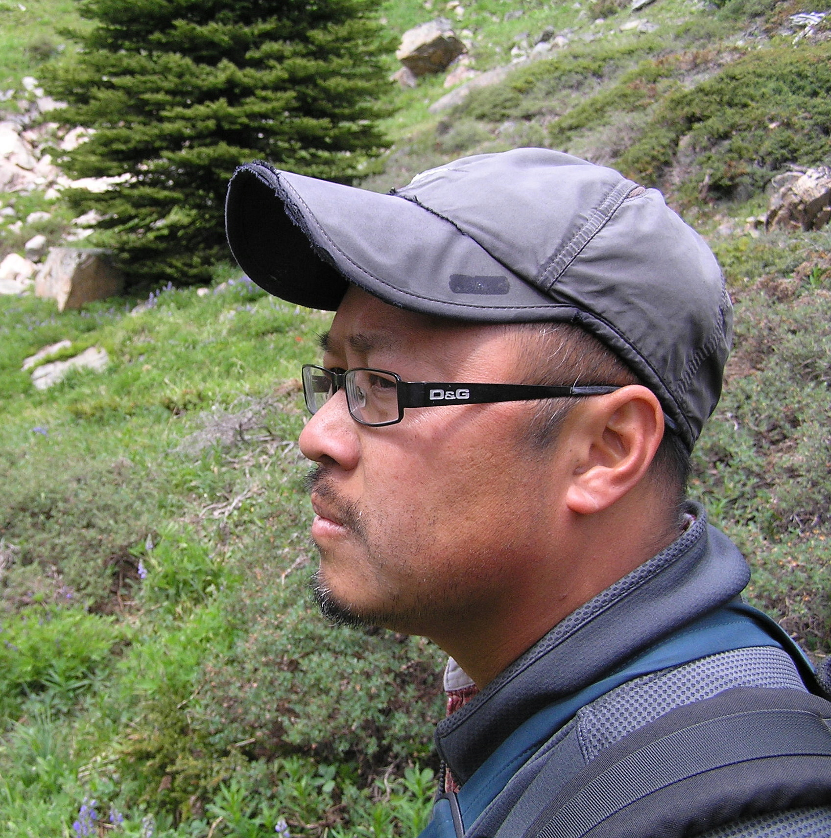 Khanh listening and looking at White winged Crossbills