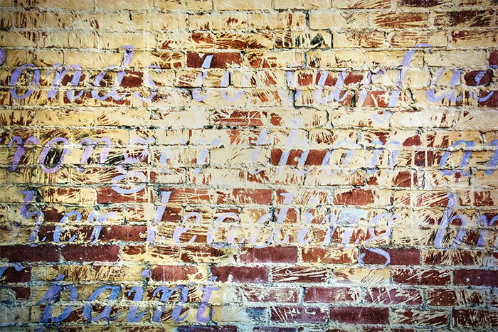 Fading Mural on a Brick Wall