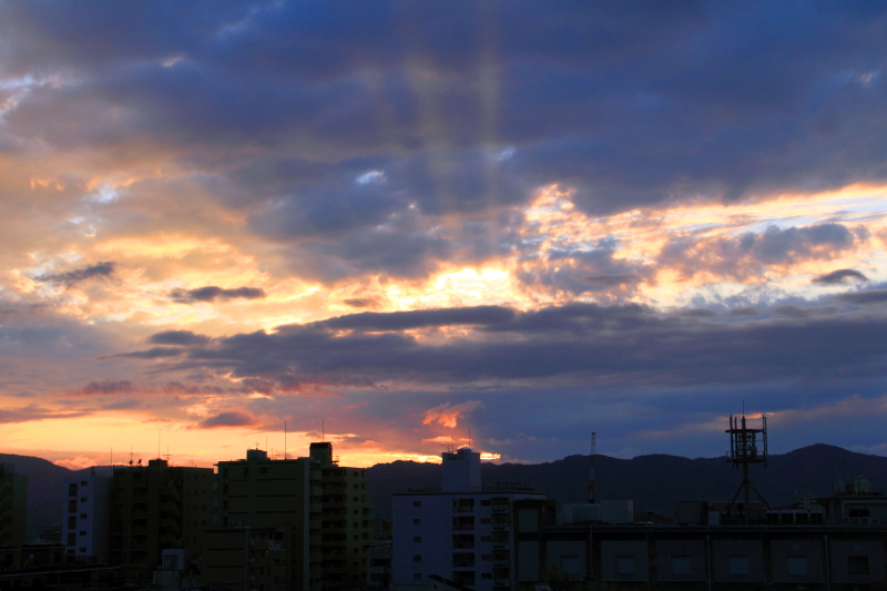 Sunrise, rays of the Sun striking Kyoto, Japan