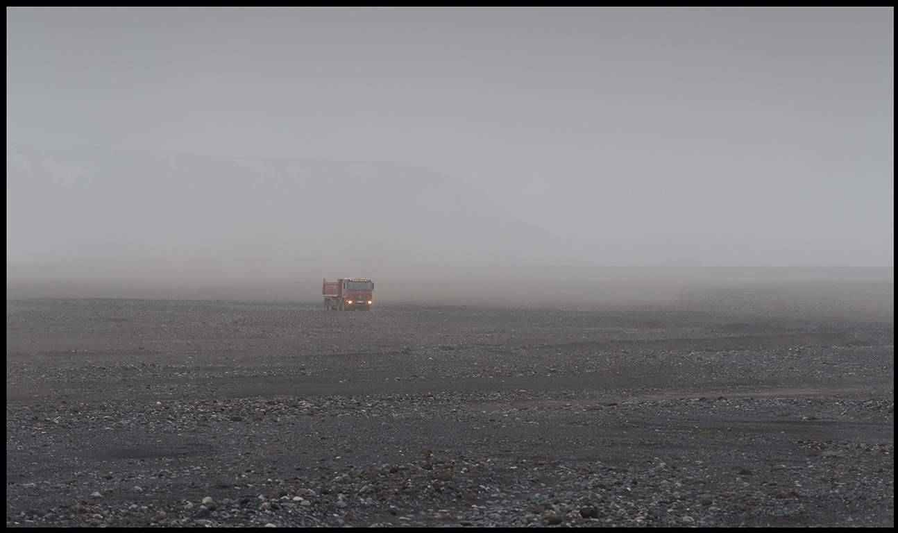 Truck in sandstorm near Vik
