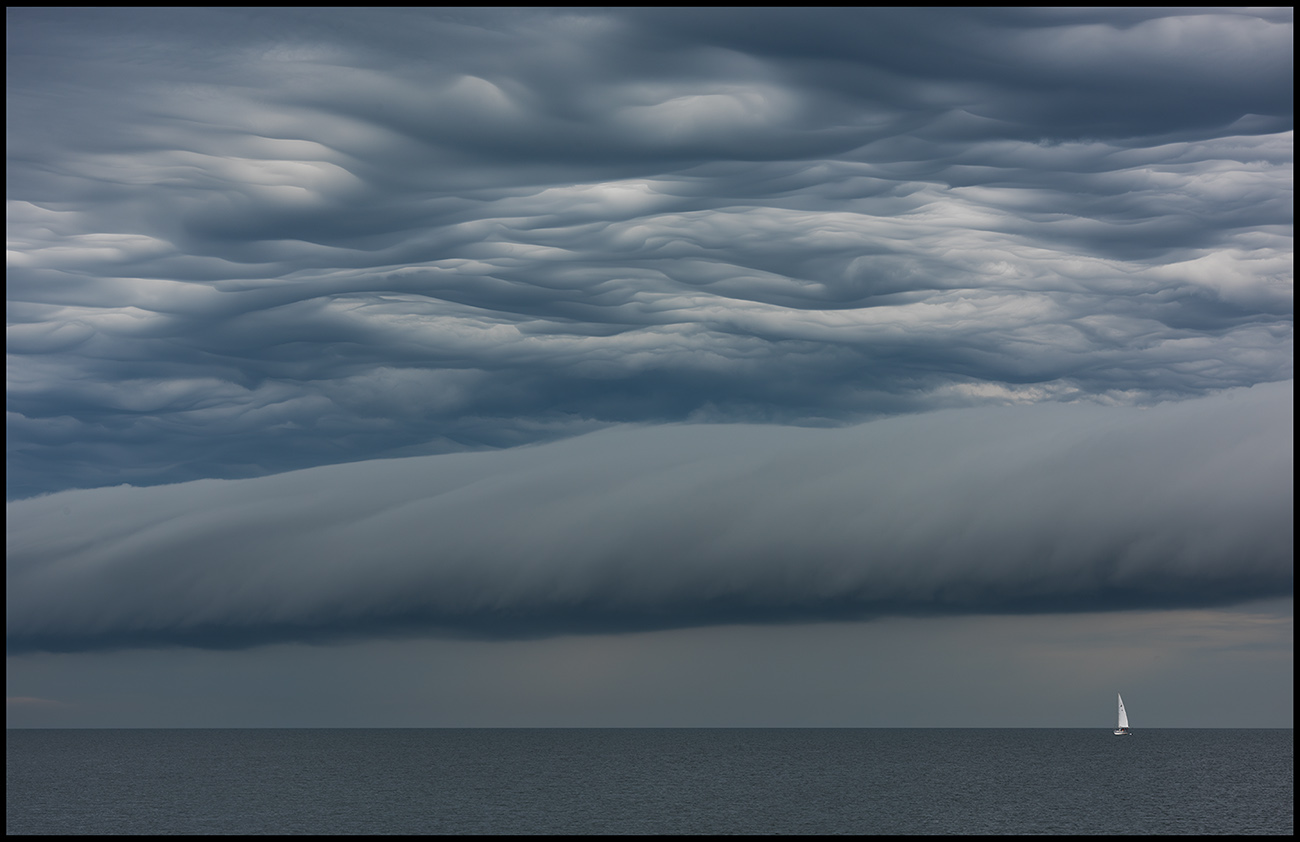 Thunderstorm approaching Ottenby with sailboat departing Grnhgen