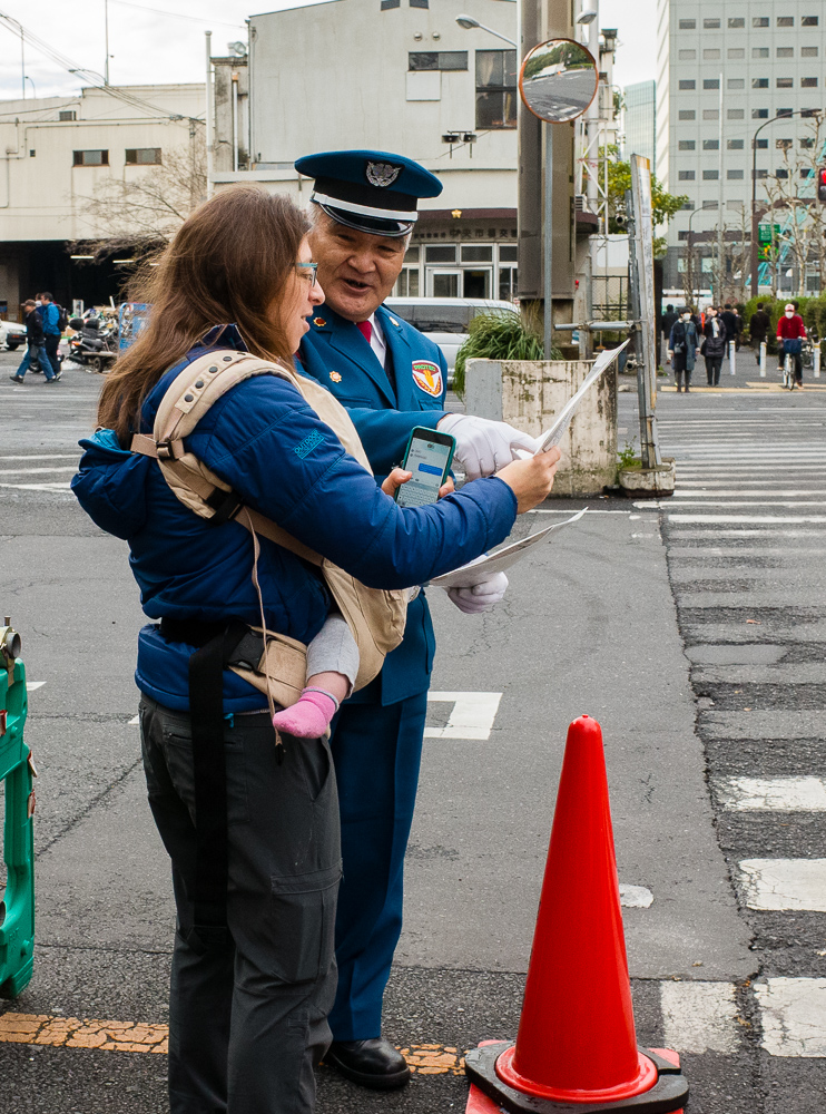 Friendly guide at fish market entrance.