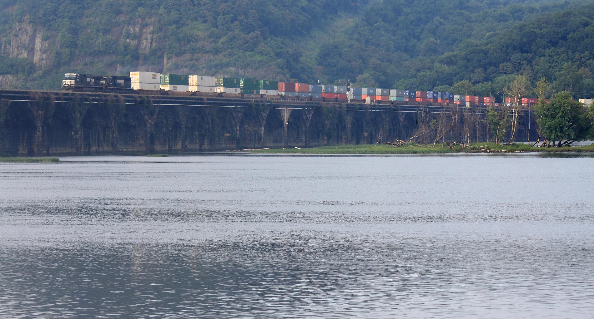 After an intense summer storm, fog is starting to form on the river as a Westbound crosses the bridge 