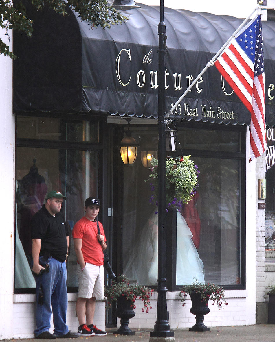 Chris and Gage, hanging out in front of a dress store on a Sunday . 