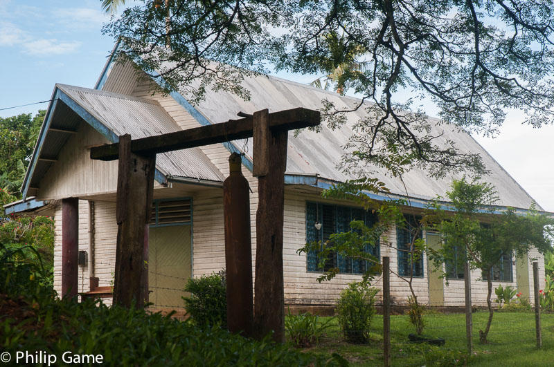 A waterfront church employs a war-time shell casing as a gong