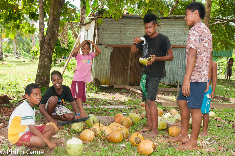 Polynesian islanders offering refreshing coconuts