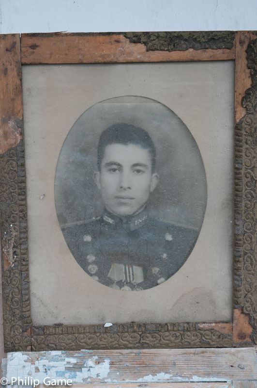Portrait of a young officer, left in the abandoned village