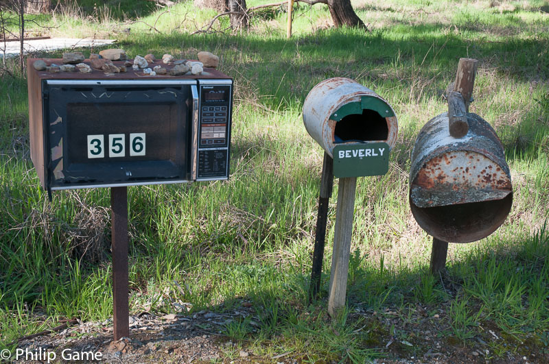 Roadside mailboxes include a recycled microwave oven