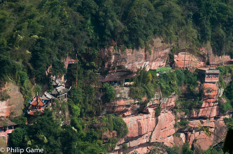 A Buddhist temple clings to the sandstone cliffs of the gorge