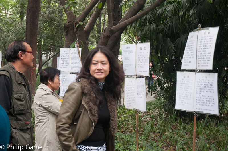 People browsing the 'marriage market' posters at Peoples Park