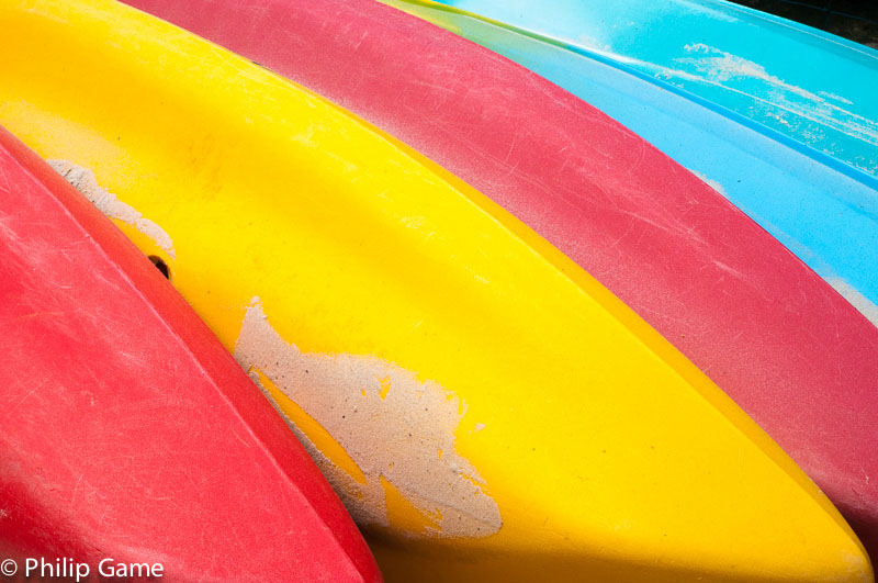 Overturned kayaks drawn up on the beach